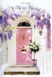 A peaceful Blackheath front step is transformed into a soft, romantic welcome by cascades of wisteria and a bucket full of roses, all arranged in a palette of pink, cream, and gentle green. The door, painted a calm, rosy pink, anchors the composition with its simple panels and slightly weathered charm, standing out against clean white walls that hold and diffuse the daylight, much like the townhouses around the Heath when the sun slips in and out of clouds. A matching shutter sits to one side, its pastel tone reinforcing the sense of balance and tranquillity. Above, long strands of wisteria hang down like floral curtains, their clusters of small blossoms in shades of lavender and soft mauve providing a natural canopy over the entrance. These blossoms catch the light and cast fleeting, lace-like shadows over the door and surrounding plaster. On the step itself, a florist's arrangement rests inside a grey, tin-like bucket, unassuming yet full of character. The bouquet brims with white and cream roses at various stages of opening, their rounded forms and generous petals creating a sense of abundance. Slender stems of fresh green foliage weave between the blooms, adding texture and a quiet hint of woodland green. Tied around the bucket is a soft pink ribbon, fashioned into a loose bow whose tails drape gently over the edge. The whole image breathes the feeling of a considered housewarming gift-perhaps delivered from a nearby Blackheath florist to a new resident settling into a flat within walking distance of the village cafés. It carries the emotions of anticipation and comfort, as though the flowers are already helping to turn an unfamiliar doorway into a place of belonging.